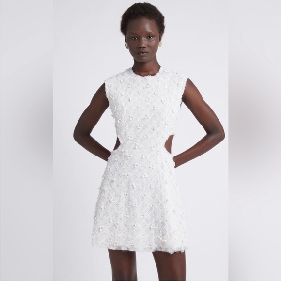 Stunning ivory white open cutting out with delicate flowers cute detailing. - Picture 10 of 16